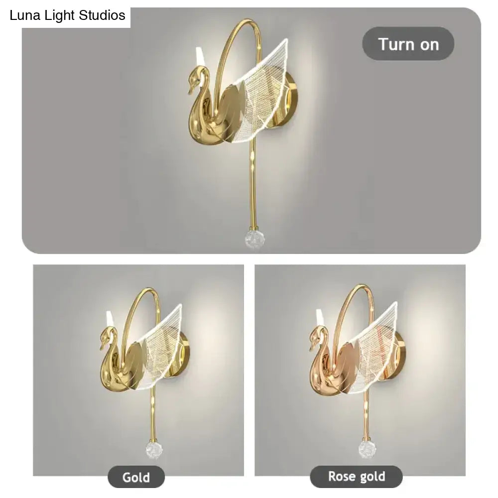 Art deco gold-toned swan wall lamp with delicate mesh wings and crystal accent for bedroom bedside wall lighting