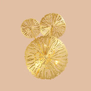 Golden intricately cut coral metal art deco wall mount light fixture with three circular tiers for bedroom sconce
