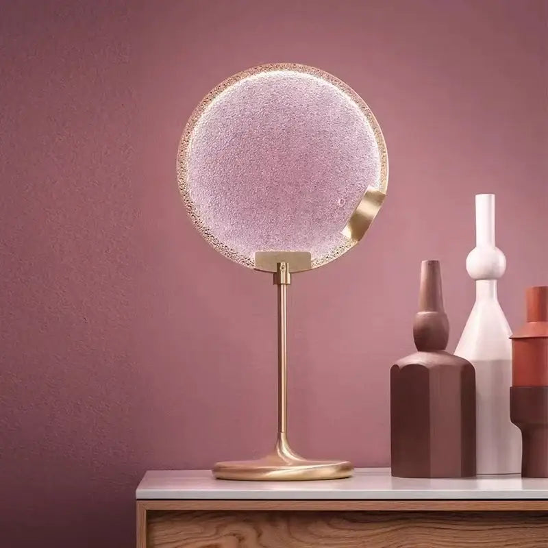 Circular vanity mirror with frosted glass and gold metallic frame complementing decorbites glass horo led pendant light