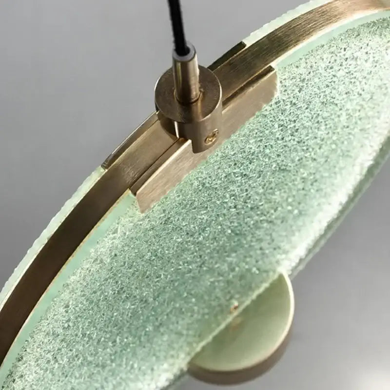 A mint-green frosted glass pendant light with brass frame from decorbites glass horo led for kitchen decor