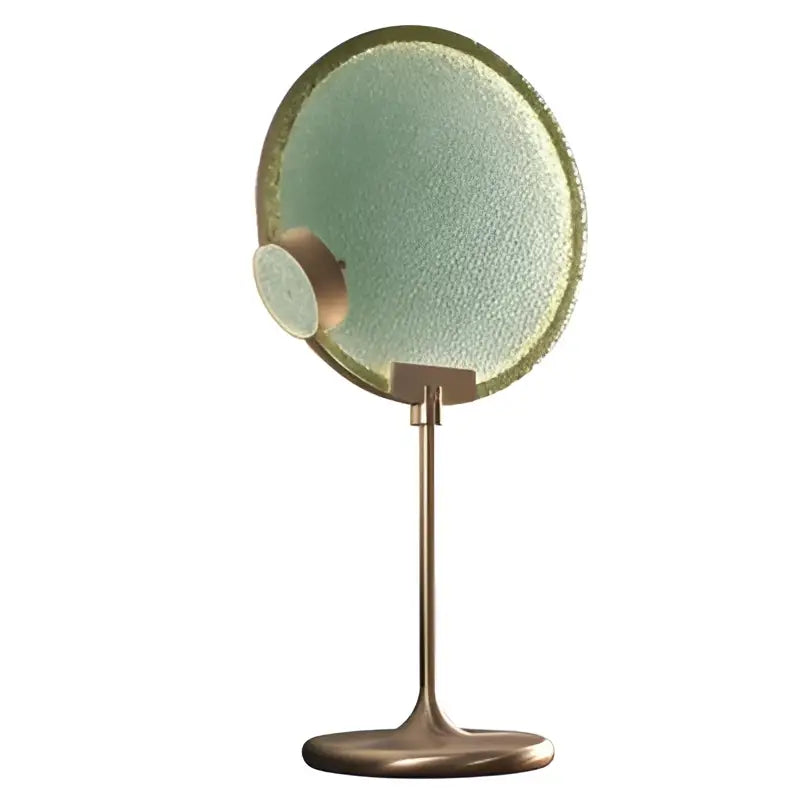 A round textured green mirror with a brass frame and stand complementing decorbites glass horo led pendant light decor