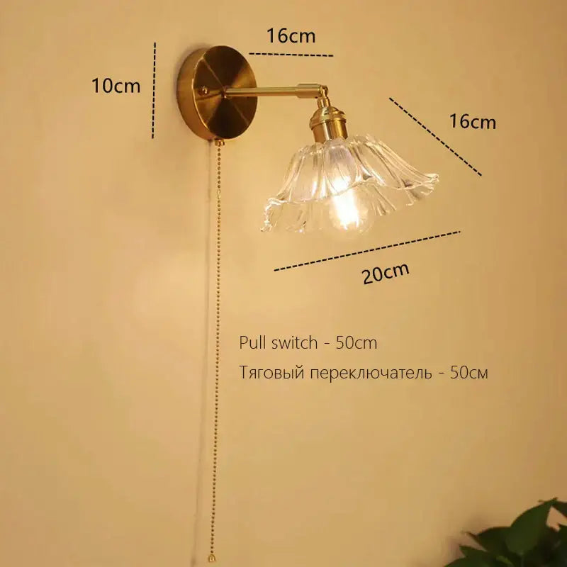 Antique brass-finished art deco led wall lamp with clear glass petal shade and exposed bulb by decorbites for bedroom decor