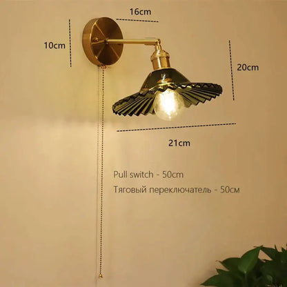 Brass-finished art deco led wall lamp with fluted dark green glass shade and exposed bulb for bedroom decorbites sconce