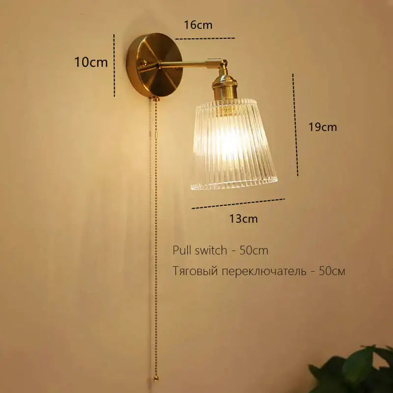 Brass-finished art deco led wall lamp with ribbed glass shade and pull chain switch decorbites art deco bedroom sconce