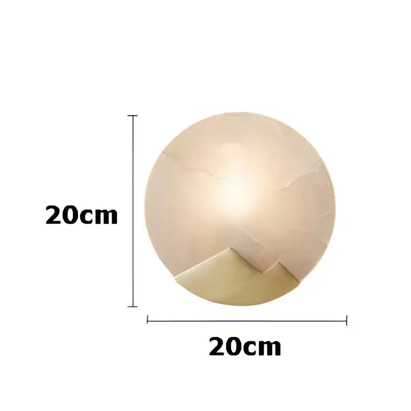 A 20cm diameter art deco marble round table lamp with a light beige marble golden lustre finish and gold-toned base
