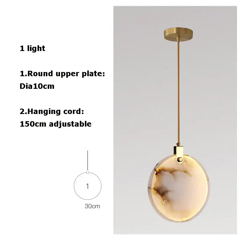 Art deco marble golden lustre pendant light with round amber and cream glass shade suspended by brass cord for dining room
