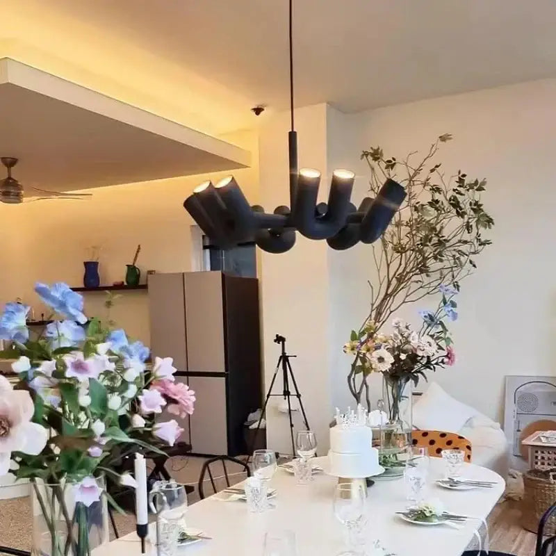 Black art deco metal industrial chandelier with angular arms and exposed bulbs for dining room decorbites art deco light