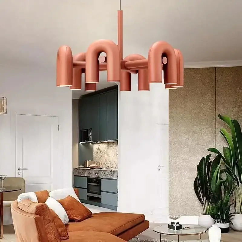 Copper-toned art deco metal industrial chandelier with curved pipe arms and integrated lighting for dining room decorbites art deco