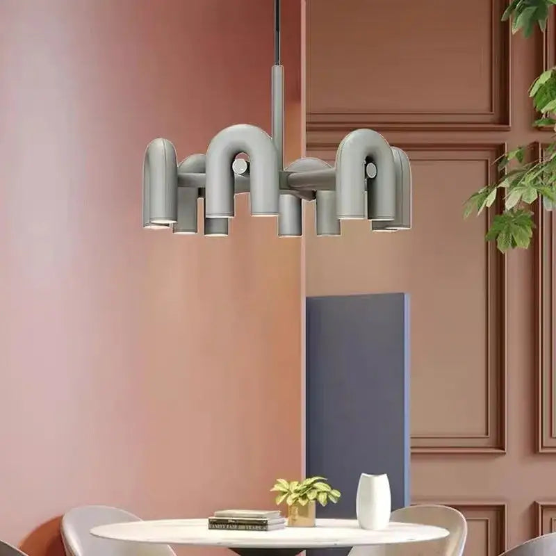 Modern gray metallic art deco metal industrial chandelier with curved pipe-like arms and circular lights for dining room decorbites art deco