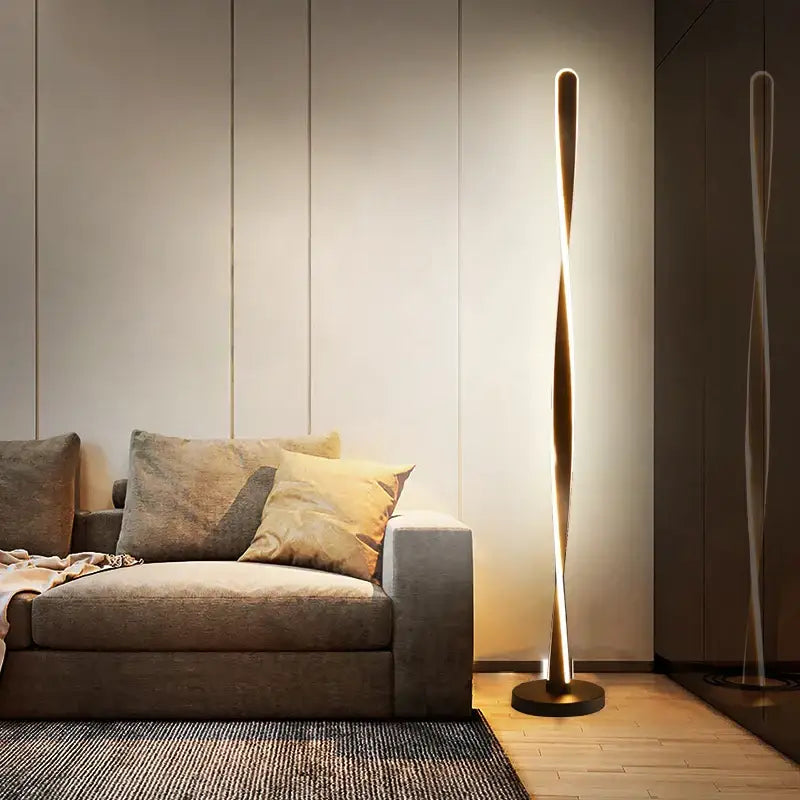 A sleek twisted gold floor lamp with art deco design by decorbites providing warm ambient living room lighting