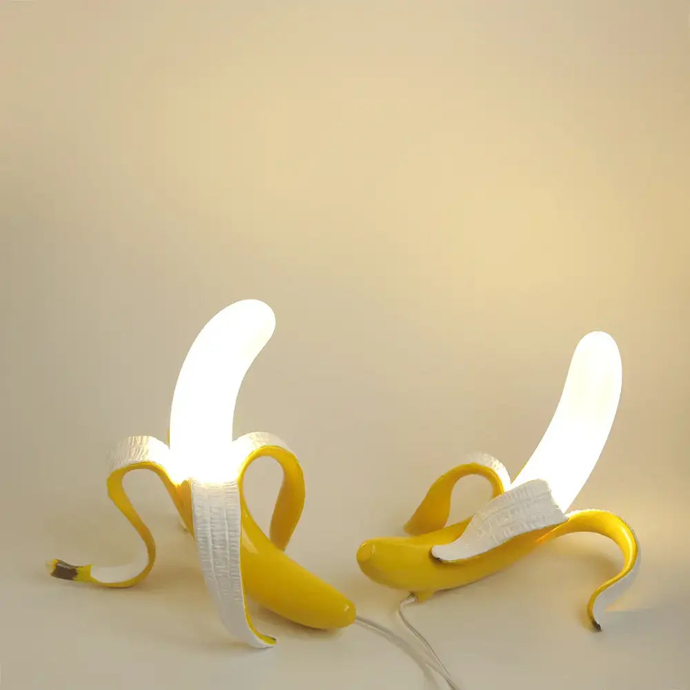 Two illuminated yellow banana-shaped lighting fixtures with decorbites glass lampshade led for bedroom decor