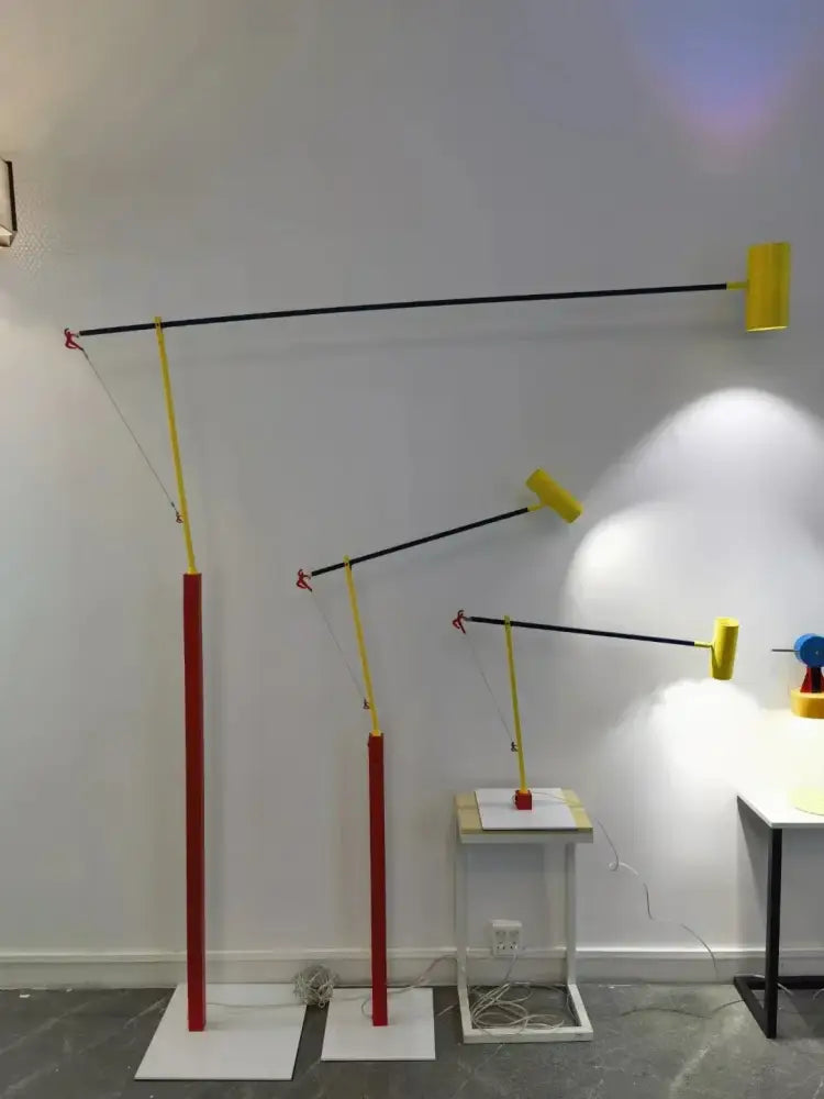 Set of three modern floor lamps with red bases black articulated arms and yellow shades for decorbites colorful cob table lighting