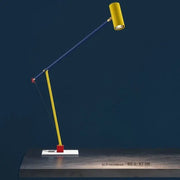A vibrant yellow and blue colorful cob table lamp with a red pivot on a white base for bedroom decorbites decor