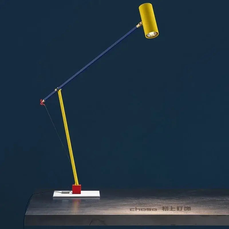 A vibrant yellow and blue colorful cob table lamp with a red pivot on a white base for bedroom decorbites decor