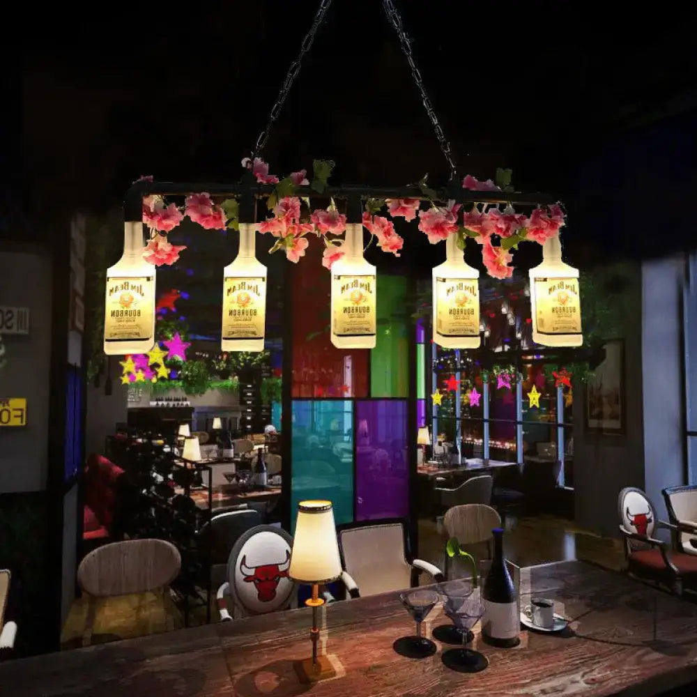 DecorBites vintage yellow bottle pendant light with metal pipe features glowing repurposed bottles and pink flowers