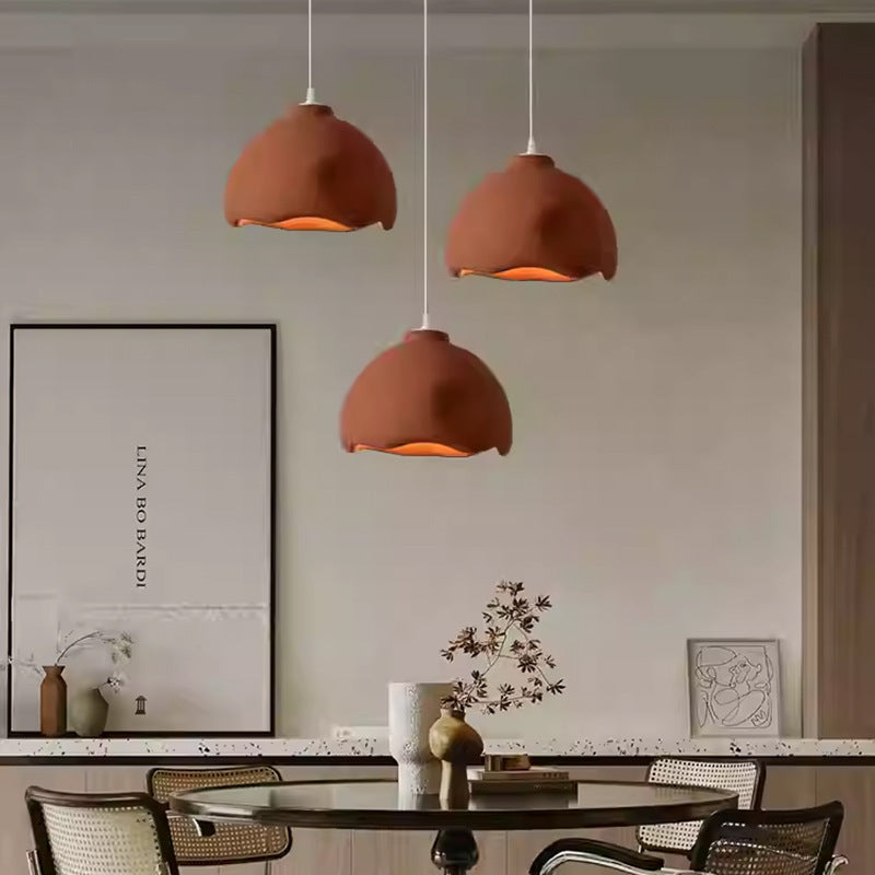 Terracotta dome pendant light set with white accents, modern design.