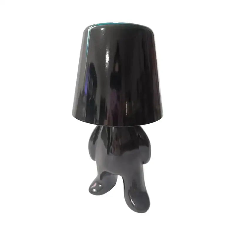 Black glossy articulated man table lamp with bucket-shaped head used as a night light for bedroom decor