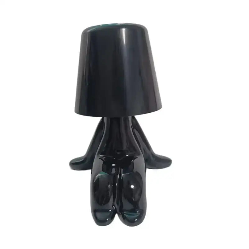Black glossy ceramic figurine night light with cylindrical lampshade in articulated golden man table lamp design