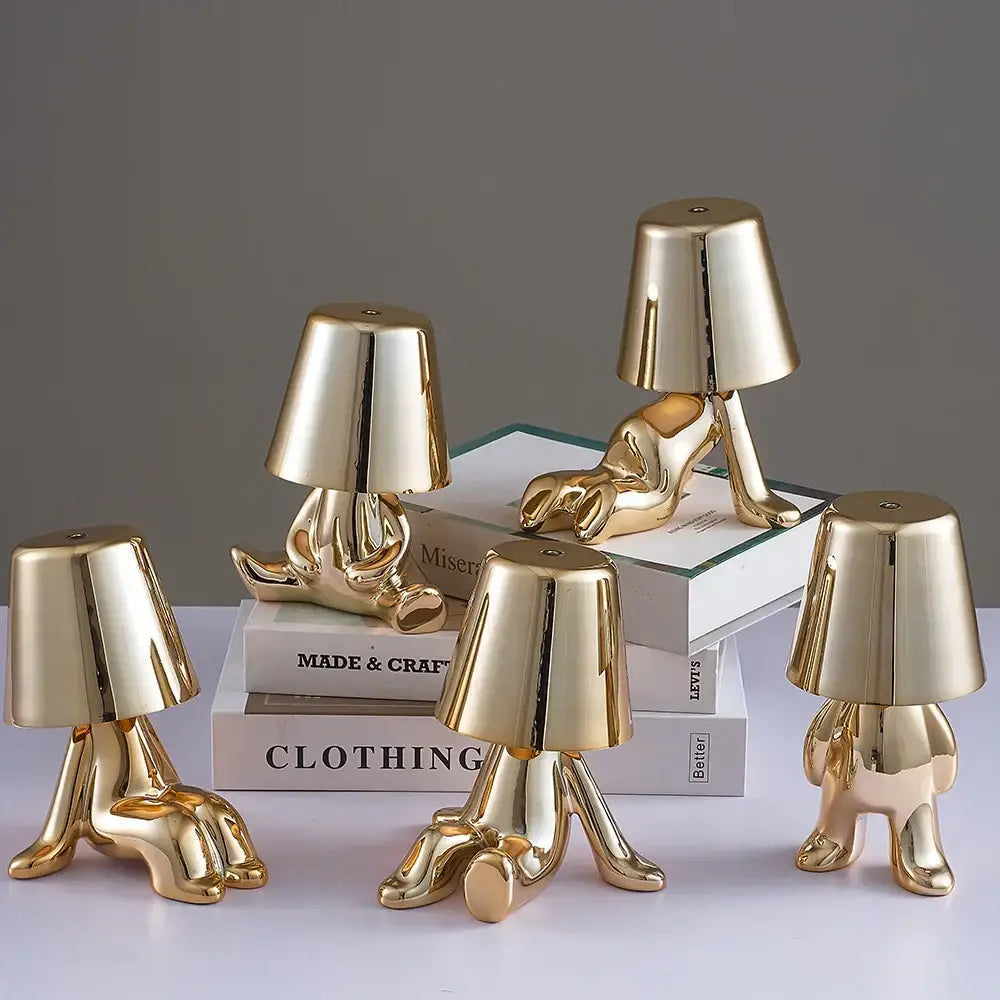 Articulated golden man table lamp with glossy ceramic abstract human form and lampshade head ideal as night light