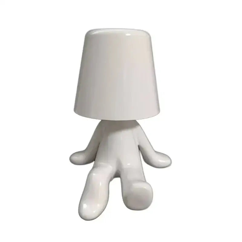 White ceramic night light with rounded bucket shade and stylized humanoid base golden man table lamp