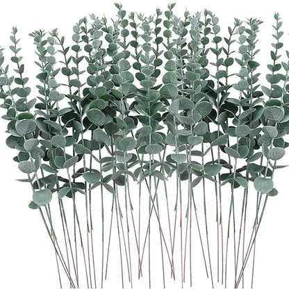 A bundle of artificial eucalyptus greenery stems with round matte green leaves and slender brown sticks for decor