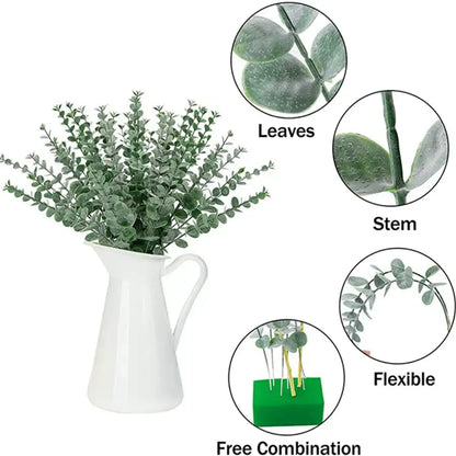 White ceramic pitcher holding artificial green eucalyptus greenery stems for living room decor display