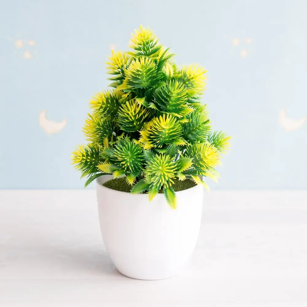 A vibrant artificial bonsai tree with green and yellow foliage in a white ceramic pot for garden decor