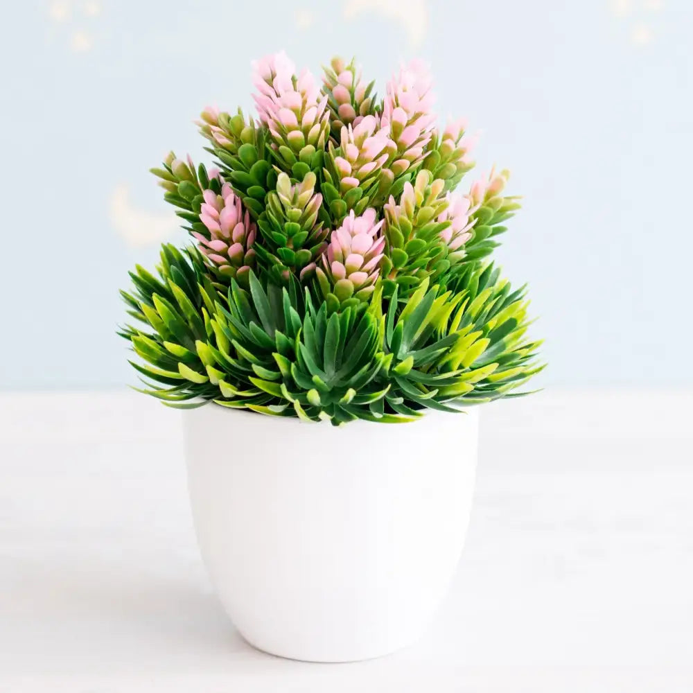 Artificial bonsai tree with vibrant green foliage and pink blossoms in a sleek white ceramic pot for garden decor