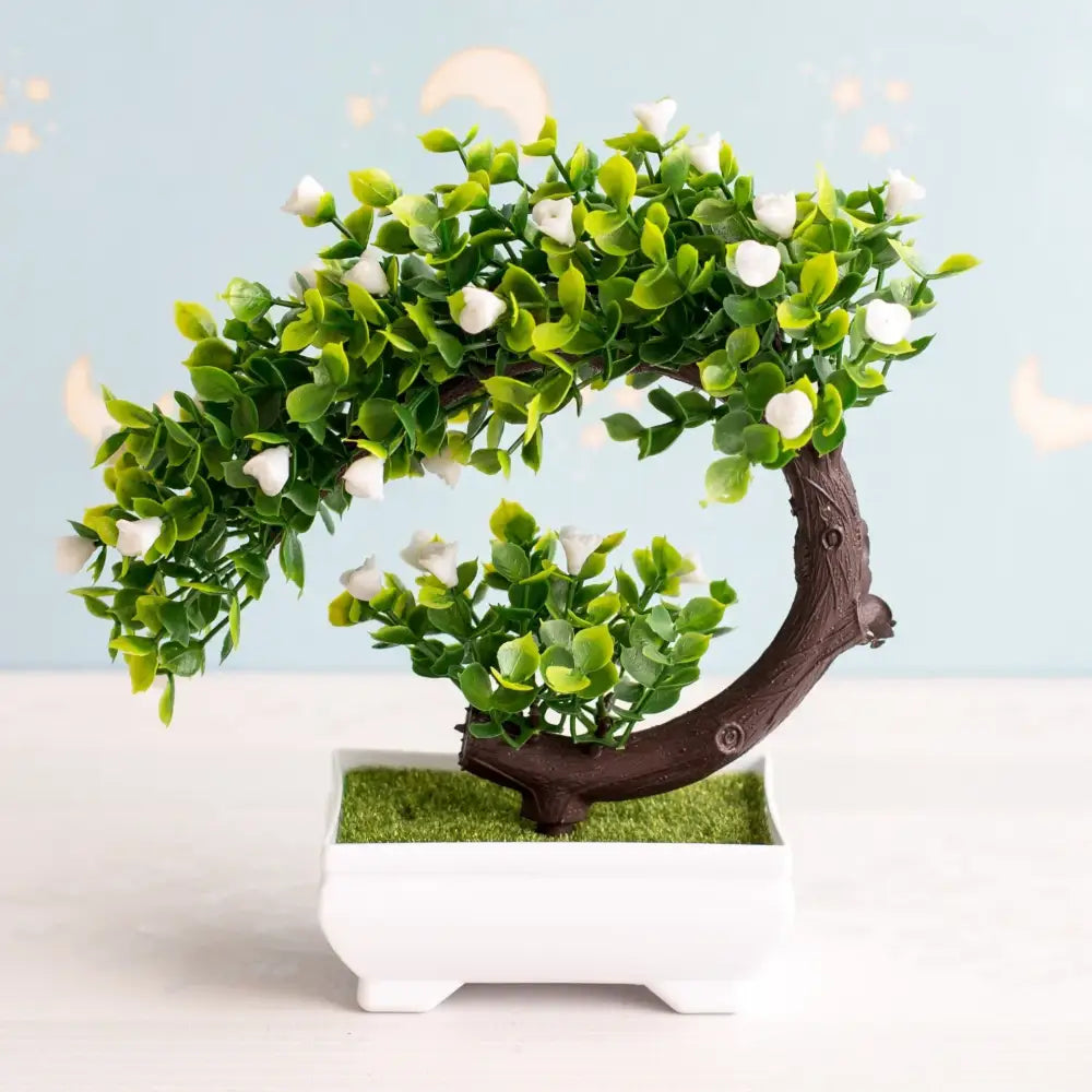 Artificial bonsai tree with lush green foliage and delicate white blossoms made from durable materials for decor