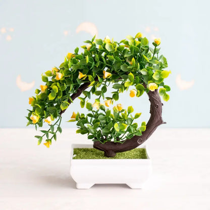 Artificial bonsai tree with lush green leaves and delicate yellow blossoms in a sleek white ceramic pot garden decor