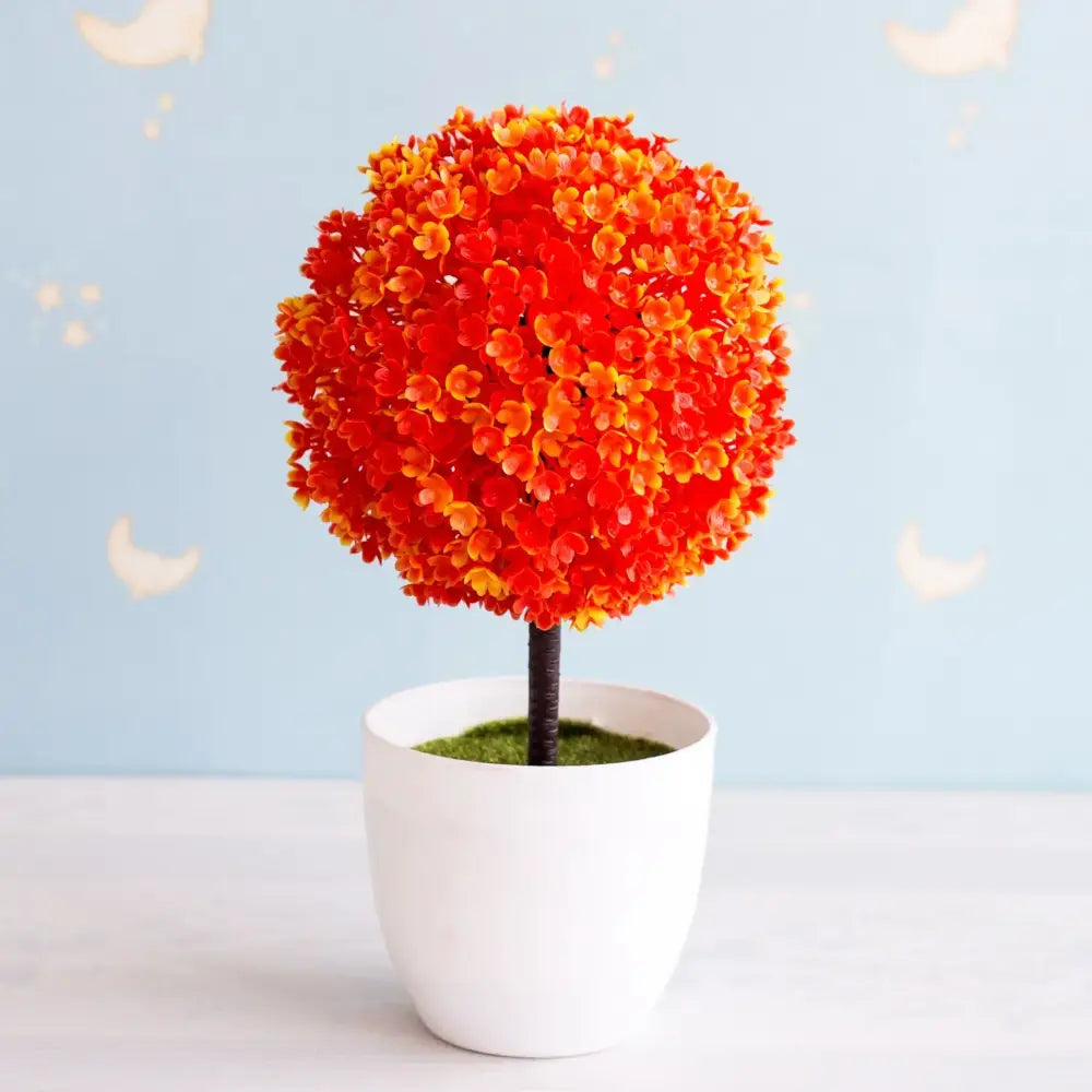 Artificial bonsai tree with vibrant orange and yellow spherical topiary in a white ceramic pot for garden decor