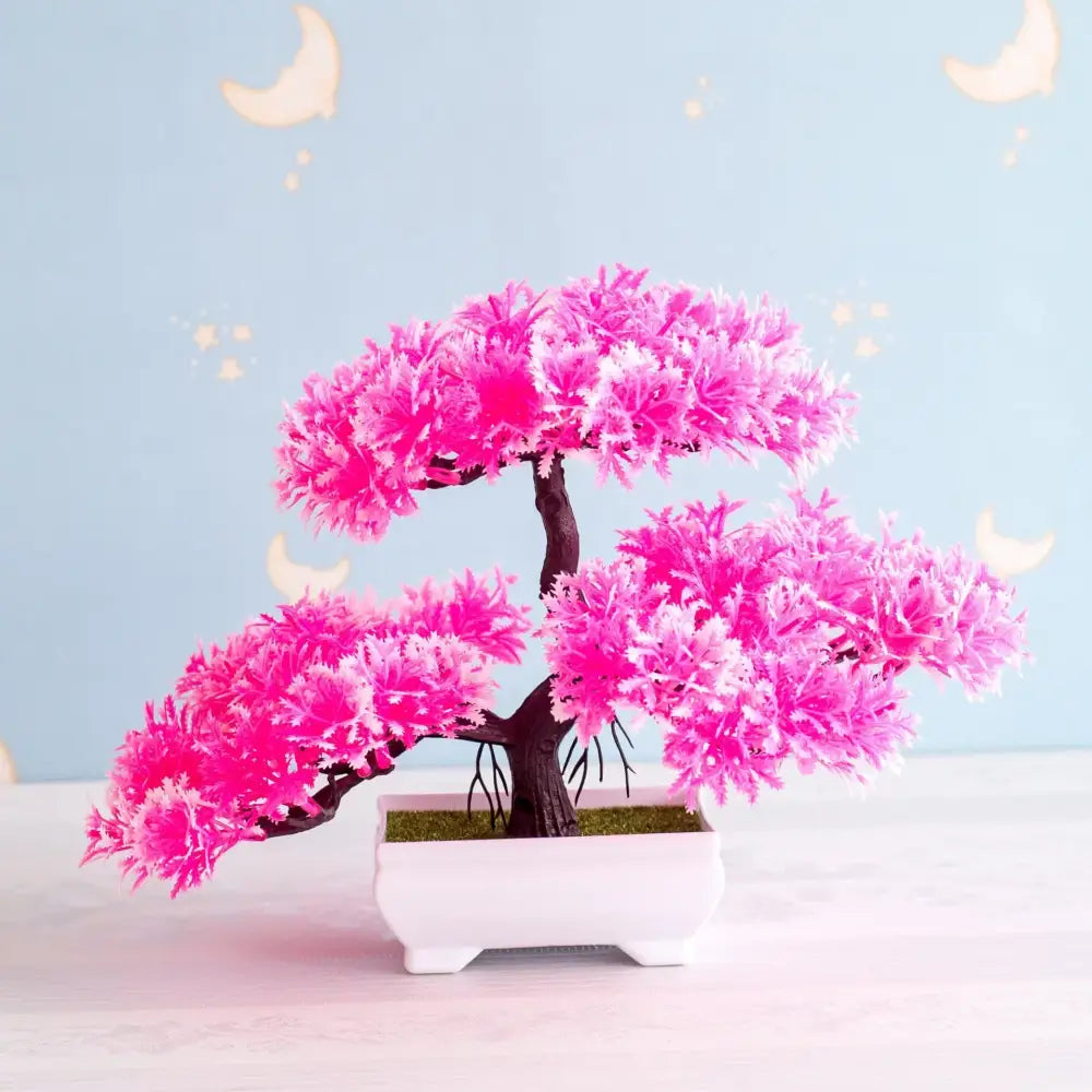 Vibrant pink artificial bonsai tree with feathery foliage and dark brown trunk in white ceramic pot for decor
