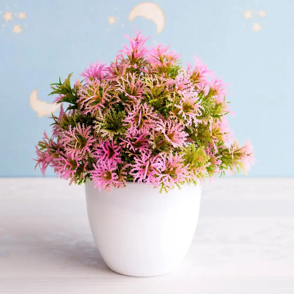 A vibrant pink and green artificial bonsai tree arrangement in a white ceramic pot for garden decor