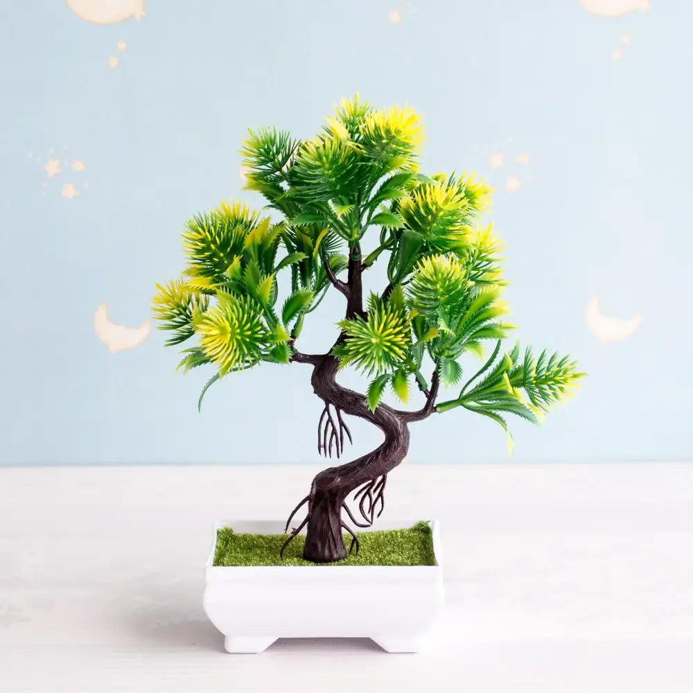 Artificial bonsai tree with dark twisted trunk and vibrant green yellow foliage in white pot with artificial moss