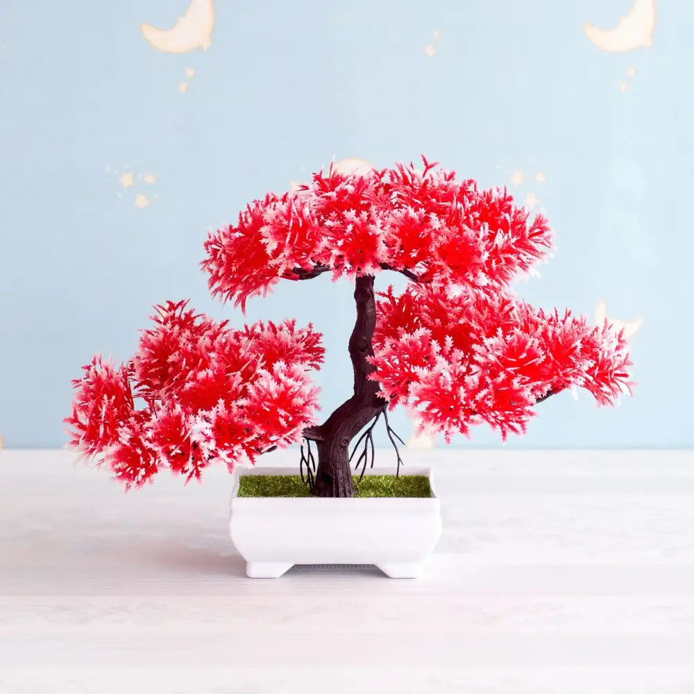A vibrant red artificial bonsai tree with frosted white tips in a sleek white ceramic pot for garden decor