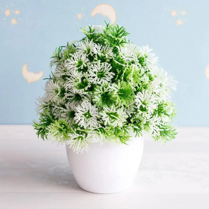 Artificial bonsai tree with feathery green and white foliage in a white ceramic pot for garden decor