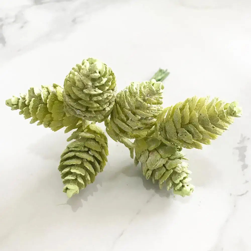 A cluster of artificial green pinecones with textured layered design in decorbites green plant flower cherry bundle decor
