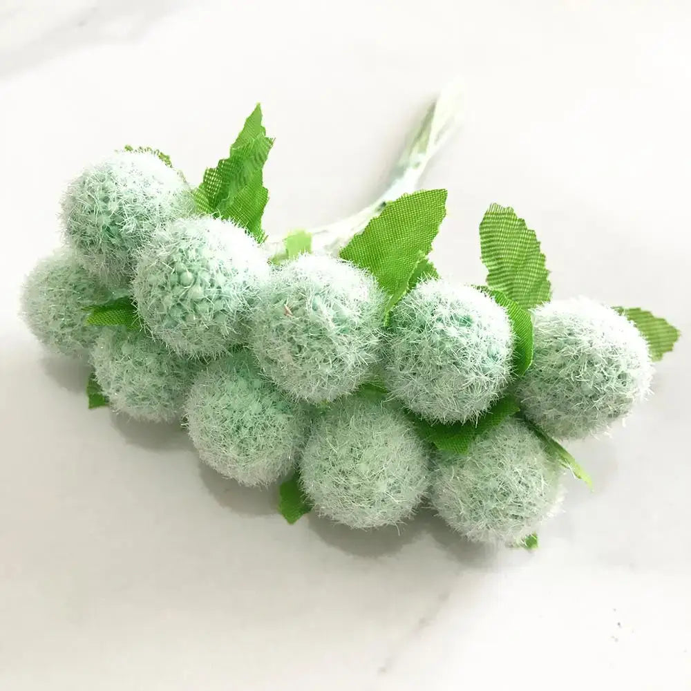 A cluster of light green fuzzy artificial grapes with small fabric leaves in decorbites green plant flower cherry bundle