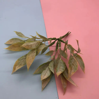 A delicate decorbites green plant flower cherry branch with muted green yellow synthetic foliage for living room decor
