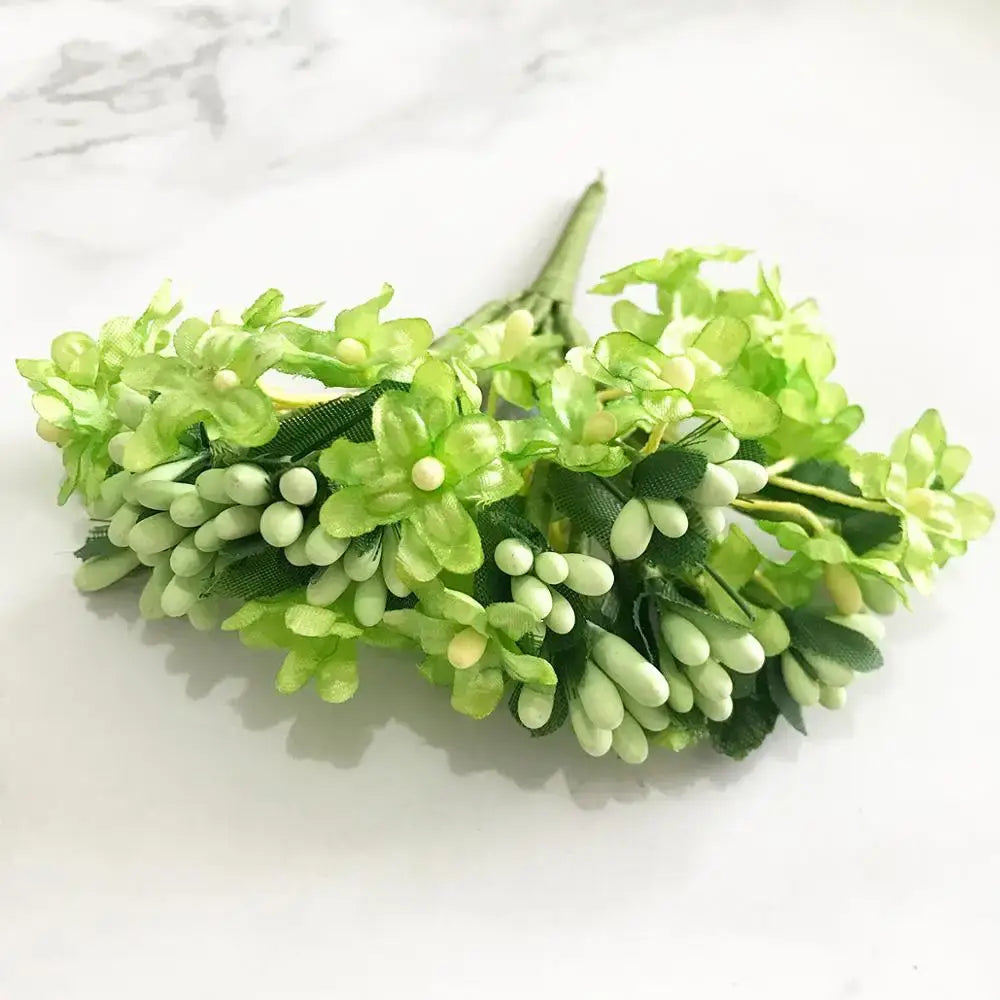 A delicate cluster of artificial green plant flower cherry berries with glossy petals and dark green fabric leaves for decorbites green plant decor