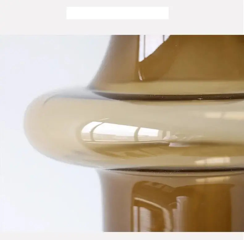 Artisan glass vase with sleek amber-tinted glass and smooth curved design for elegant decor and art glass collection