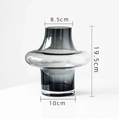 Artisan glass vase with a sleek modern design featuring a gradient gray to clear finish and a bulbous midsection