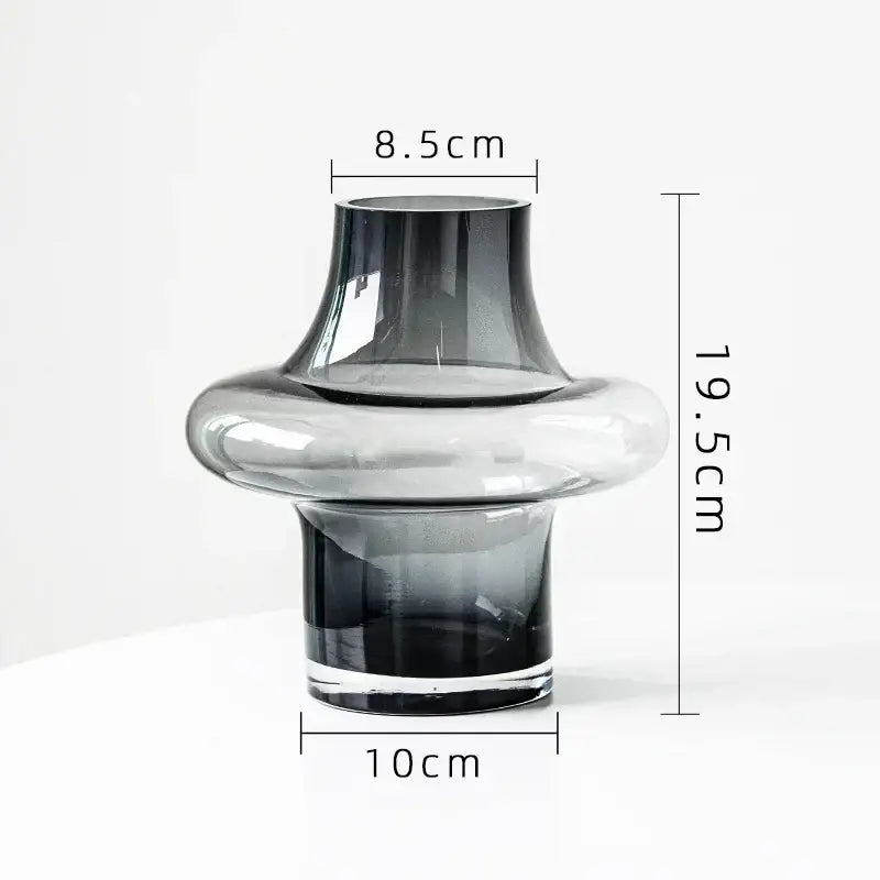 Artisan glass vase with a sleek modern design featuring a gradient gray to clear finish and a bulbous midsection