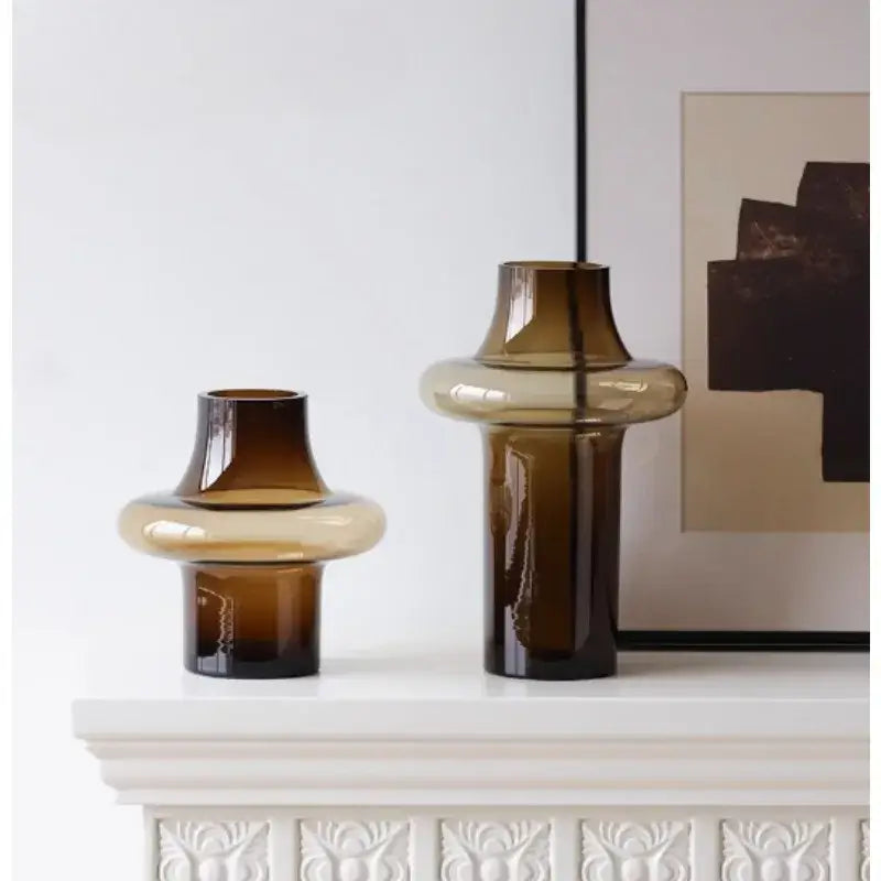 Artisan glass vase set featuring two amber-tinted sculptural vases with bulbous midsections and tapered necks