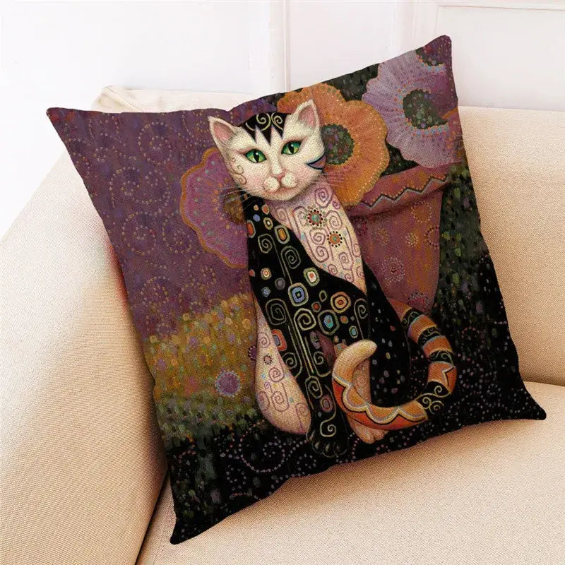 Square cushion with decorbites cat print in black and cream featuring green eyes and art nouveau geometric patterns