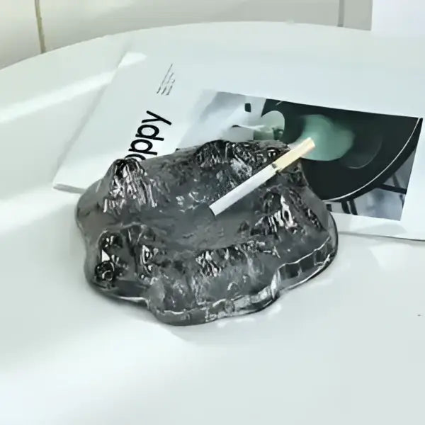 A translucent gray glass ashtray with a textured surface complementing decorbites iceberg glass dessert plate decor