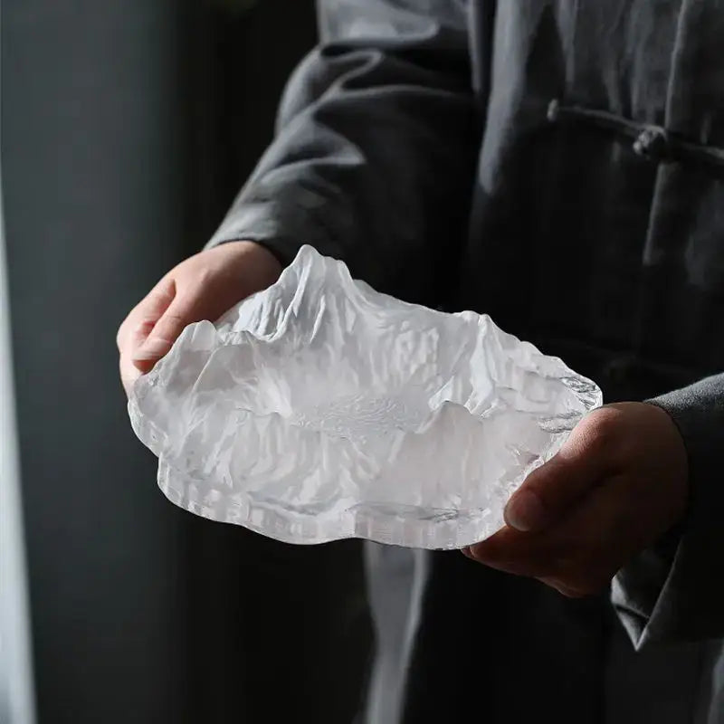 Artistic clear and gold decorbites iceberg glass dessert plate featuring a transparent intricately carved mountain design
