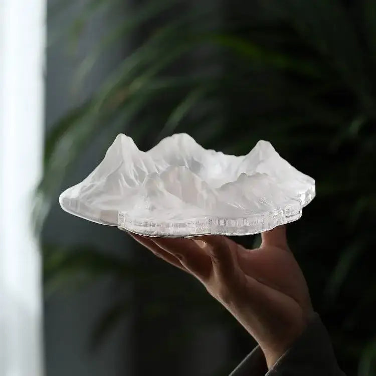 Artistic translucent white decorbites iceberg glass dessert plate shaped like a mountain range with intricate ridges