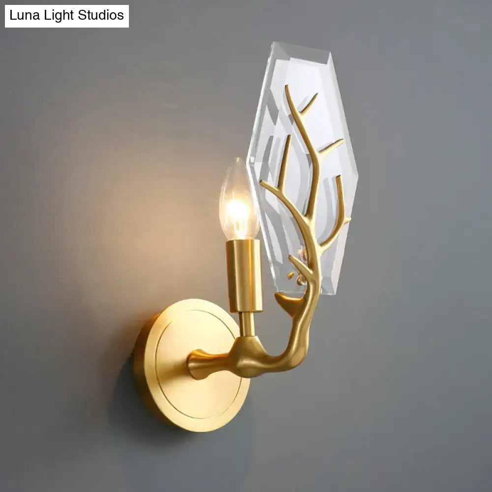 Artistic gold-toned antler wall lamp with faceted crystal backplate for elegant living room light fixture