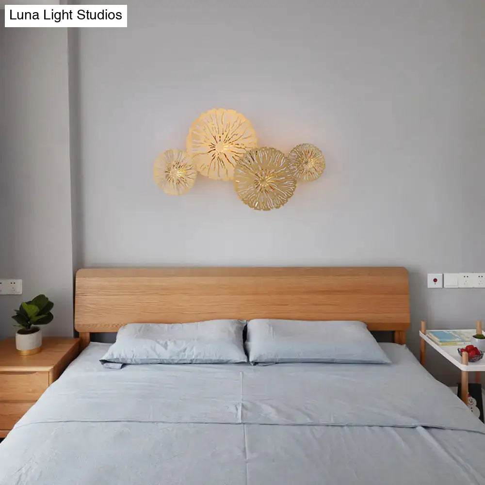 Artistic golden lotus leaf sconce light fixture featuring intricately woven design for modern minimalist living room wall art